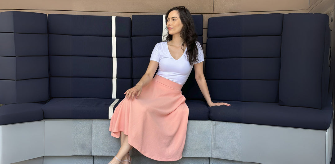 Missy Size Small Lady wearing a peach midi Skirt seating down relaxing