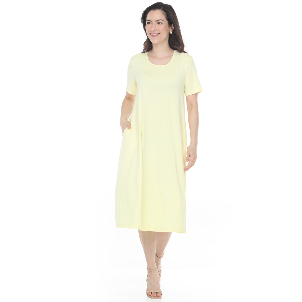 Woman wearing a casual tee swing midi dress with pockets in yellow